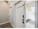 Interior entryway with white door and hardwood flooring at 9142 Brooker Dr, New Port Richey, FL 34655