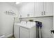 Clean laundry room with washer, dryer, and ample cabinet space at 9142 Brooker Dr, New Port Richey, FL 34655