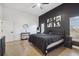 Main bedroom with dark accent wall, large bed and natural light at 9142 Brooker Dr, New Port Richey, FL 34655