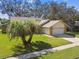Single-story home with stone facade and two-car garage at 9142 Brooker Dr, New Port Richey, FL 34655