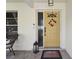 Front door entry featuring a stylish yellow door and Halloween wreath at 9142 Brooker Dr, New Port Richey, FL 34655