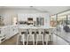 Spacious kitchen with white cabinets, stainless steel appliances, and an island with seating at 9142 Brooker Dr, New Port Richey, FL 34655