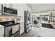 Modern kitchen featuring stainless steel appliances and white cabinetry at 9142 Brooker Dr, New Port Richey, FL 34655
