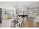 Open concept dining area with hardwood floors and farmhouse style table at 9142 Brooker Dr, New Port Richey, FL 34655