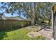Backyard with large oak trees and a stone patio at 9142 Brooker Dr, New Port Richey, FL 34655