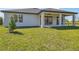 House exterior view showcasing a covered patio and yard at 12125 Finch Rd, Weeki Wachee, FL 34614