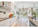 Bright kitchen with white cabinets and eat-in area at 11313 Limpkin Rd, Weeki Wachee, FL 34614