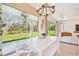White table with bench seating, sliding glass doors to backyard at 11313 Limpkin Rd, Weeki Wachee, FL 34614