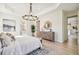 Main bedroom with dresser, large bed, and ensuite bathroom access at 11313 Limpkin Rd, Weeki Wachee, FL 34614