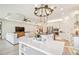 Open concept kitchen with white cabinets, large island and stainless steel appliances at 11313 Limpkin Rd, Weeki Wachee, FL 34614