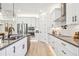Modern white kitchen with stainless steel appliances and dark countertops at 11313 Limpkin Rd, Weeki Wachee, FL 34614