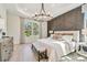 Main bedroom featuring a large bed and geometric accent wall at 11313 Limpkin Rd, Weeki Wachee, FL 34614