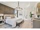 Main bedroom with large bed, chandelier, and ensuite bathroom at 11313 Limpkin Rd, Weeki Wachee, FL 34614