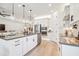 Modern kitchen with white cabinets, stainless steel appliances, and a large island at 11313 Limpkin Rd, Weeki Wachee, FL 34614