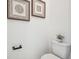 Small half bathroom with toilet and decorative wall art at 11313 Limpkin Rd, Weeki Wachee, FL 34614