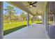 Covered patio with ceiling fans overlooking a grassy backyard at 11313 Limpkin Rd, Weeki Wachee, FL 34614
