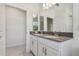 Double vanity bathroom with gray countertops and a view into another room at 11578 Weaver Hollow Rd, New Port Richey, FL 34654