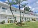 Exterior view of a light-colored apartment building with landscaping at 11200 86Th Ave # 204, Seminole, FL 33772