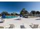 Relaxing community pool area with lounge chairs and umbrellas at 11200 86Th Ave # 204, Seminole, FL 33772