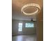 Living room features a ceiling fan and a large chandelier at 11200 86Th Ave # 204, Seminole, FL 33772