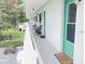 Community hallway with teal doors and seating area, overlooking a grassy lawn at 11200 86Th Ave # 204, Seminole, FL 33772