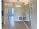 Hallway with tile floors, large mirrors, and a modern chandelier at 11200 86Th Ave # 204, Seminole, FL 33772