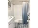 Updated bathroom with white vanity, tub, and patterned floor at 11200 86Th Ave # 204, Seminole, FL 33772