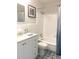 Updated bathroom with white vanity, tub, and patterned floor at 11200 86Th Ave # 204, Seminole, FL 33772