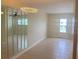 Bright living room with tile floors, chandelier, and mirrored wall at 11200 86Th Ave # 204, Seminole, FL 33772