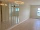 Living room with tile floors, large mirrors, ceiling fan and chandelier at 11200 86Th Ave # 204, Seminole, FL 33772