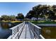 Scenic footbridge over the lake offering a peaceful view at 11200 86Th Ave # 204, Seminole, FL 33772