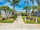 Community entrance with lush landscaping and palm trees at 11200 86Th Ave # 204, Seminole, FL 33772