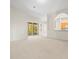 Open living room with access to a back patio and kitchen at 4264 Braemere Dr, Spring Hill, FL 34609