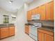 Bright kitchen with light wood cabinets, granite countertops, and stainless steel appliances at 4264 Braemere Dr, Spring Hill, FL 34609