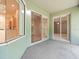 Bright enclosed patio with glass sliding doors leading to an open space at 4264 Braemere Dr, Spring Hill, FL 34609