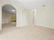 Open living area with high ceilings, neutral color palette, and arched alcoves at 4264 Braemere Dr, Spring Hill, FL 34609