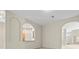 Living room with kitchen pass-through and views to entryway at 4264 Braemere Dr, Spring Hill, FL 34609
