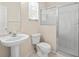 Clean bathroom with pedestal sink, toilet and shower stall at 4264 Braemere Dr, Spring Hill, FL 34609