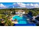 Resort-style pool and clubhouse with palm trees and lush landscaping at 6109 Dusk Rose Ln, Brooksville, FL 34601