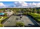 Community tennis courts with surrounding landscape and clubhouse at 6109 Dusk Rose Ln, Brooksville, FL 34601