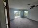 Spacious bedroom with carpet flooring and access to a balcony at 6428 Driftwood Dr, Hudson, FL 34667
