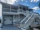 Two-story home with white exterior, balcony, and attached garage at 6428 Driftwood Dr, Hudson, FL 34667