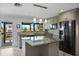 Modern kitchen featuring granite island, stainless steel appliances, and water views at 6428 Driftwood Dr, Hudson, FL 34667