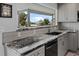 Modern kitchen features granite countertops and stainless steel appliances at 6428 Driftwood Dr, Hudson, FL 34667