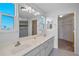 Bathroom with double vanity, walk-in shower, and a large closet at 6428 Driftwood Dr, Hudson, FL 34667