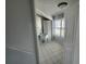 Bright laundry room with white tile floor and a window at 6428 Driftwood Dr, Hudson, FL 34667