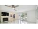 Bright living room featuring a fireplace, ample natural light, and stylish tile flooring at 12212 Buttonwood Row, Hudson, FL 34667