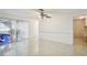 Spacious living room featuring tile flooring, a ceiling fan, and sliding glass doors leading to an outdoor area at 12212 Buttonwood Row, Hudson, FL 34667