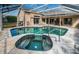 Relaxing pool and spa area with a covered patio at 1810 Kinsmere Dr, Trinity, FL 34655