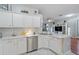 Updated kitchen with white cabinetry, quartz countertops, and stainless steel appliances at 20804 Eustis Rd, Land O Lakes, FL 34637